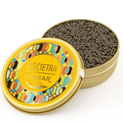 Angled view of an open Caviar d'Eden Oscietra tin, showcasing the premium dark sturgeon roe alongside its signature yellow patterned lid