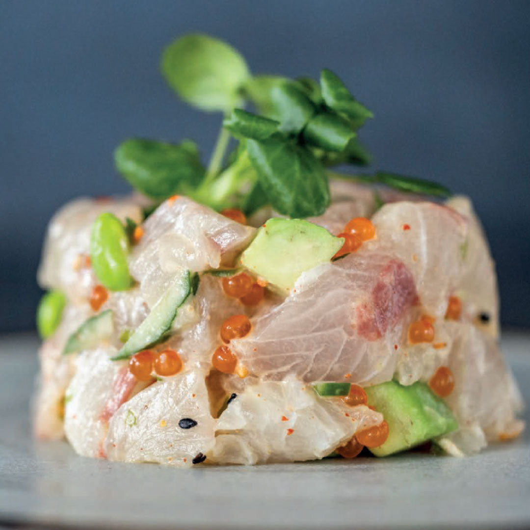 Hiramasa (yellowtail kingfish) tartare served as a moulded stack, with diced avocado, cucumber, and tobiko (flying fish roe), topped with fresh microgreens. Part of a WasteNot recipe series promoting whole-fish cookery and reducing kitchen food waste.